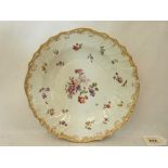 A 19th century Vienna deep dish, painted in coloured enamels with scattered flowers within a