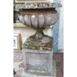 A garden statuary urn of country house proportion, on square socle and stepped base. 57' high