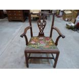 A George III mahogany 'Chippendale' elbow chair, the foliate carved back with tracery pierced splat,