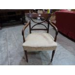 A George IV mahogany elbow chair with reeded arms on turned legs