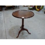 A 19th century mahogany snap-top occasional table, the round dish top with inlaid rim, on tapered