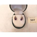 A pair of 9ct amethyst and diamond earrings. 1.2g gross