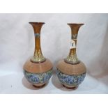 A pair of Doulton Lambeth ware vases, the body decorated with continuous band of blue flowers and