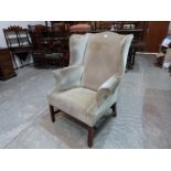 A George III wing armchair on chamfered square legs
