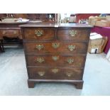 An 18th century oak chest of two short over three long drawers on bracket feet. 34' wide