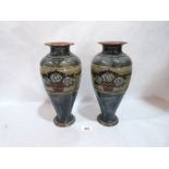 A pair of Royal Doulton inverted baluster vases, brush line decorated with tubs of roses on a