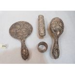 A silver hand mirror, hairbrush and clothes brush, repousse decorated with Reynolds' angels;
