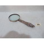 A silver handled magnifying glass. 8½' long