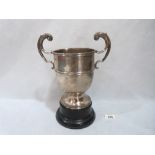 A Victorian silver two handled cup on trophy stand. London 1859. 8¾' high. 24ozs 5dwts
