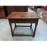 An early 18th century joined oak side table with carved frieze drawer, on turned legs and square