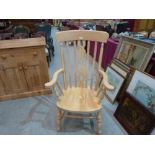 A beechwood elbow chair on turned splayed legs