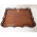 A 19th century mahogany gallery tray of shaped outline, formerly a table top. 24' wide
