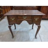 An 18th century joined oak lowboy fitted with three drawers, on square cabriole legs. 32' wide