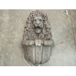 A composition lion wall fountain. 26' high