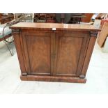 A 19th century mahogany pier cabinet, enclosed by a pair of panel doors with pilasters flanking.