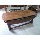 An oak dropleaf low table. 48' wide