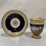 A Chamberlain Worcester cup and saucer, cobalt blue glazed and gilded, painted in reserve with a