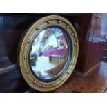 A convex wall mirror. 21' diam