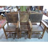 A set of six oak chairs with pigskin seats and backs, the set to include two carvers