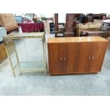 A gilt metal display case and a mid century cabinet enclosed by four doors