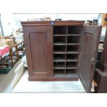 A Victorian mahogany cabinet, the pair of panel doors enclosing twenty four pigeon holes. 27' high