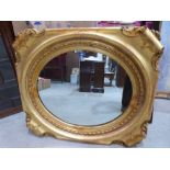 A 19th century giltwood and gesso looking glass with oval plate. 36' wide