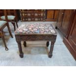 An oak bidet stool with tapestry seat, the frieze carved with vine fruits on barleytwist legs