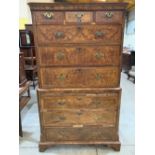 An 18th century walnut and burr veneered chest on chest with reeded canted sides on bracket feet.