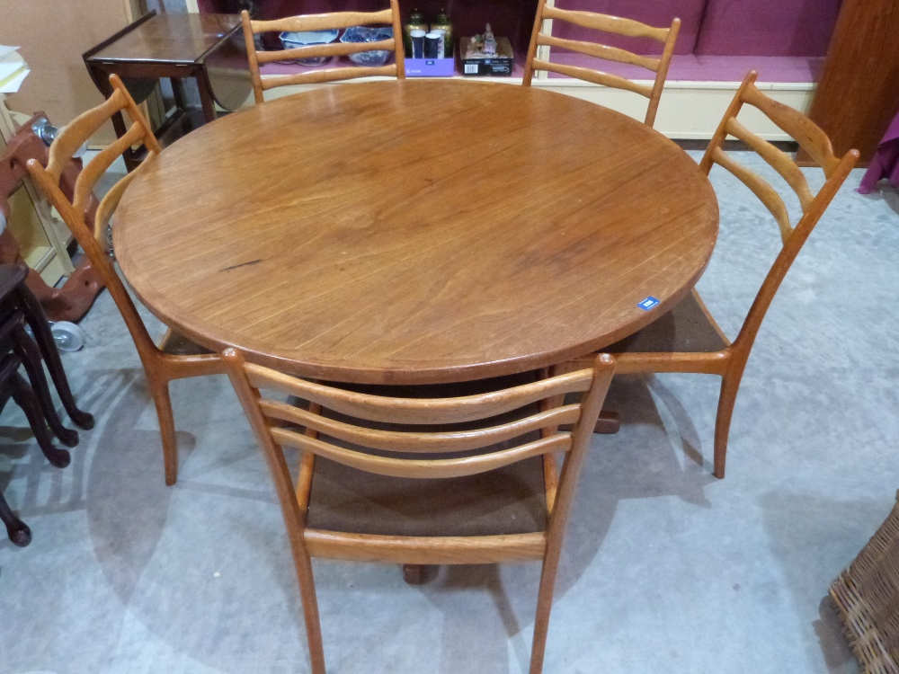A 1970s G-Plan teak dining table and five chairs, the table with extra leaf extending to 68' long