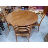 A 1970s G-Plan teak dining table and five chairs, the table with extra leaf extending to 68' long