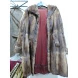 A vintage fur coat with a box of fur collars