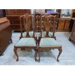 A set of four early 20th century mahogany dining chairs in Queen Anne style