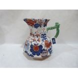 A Masons Ironstone jug decorated in imari palette. 9½' high. Cracked