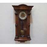 A walnut Vienna wall clock, the two train movement striking on a coiled gong. 33' high