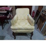 An 18th century upholstered armchair on shell moulded walnut cabriole legs. (All legs with lower