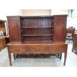 An 18th century joined oak and mahogany banded dresser, the raised rack with three shelves and