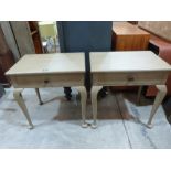 A pair of painted bedside tables, each with a frieze drawer on cabriole legs. 26' wide