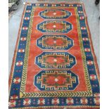 A red ground Turkish rug. 84' x 53'