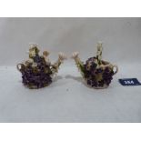 A pair of continental porcelain flower encrusted models of watering cans. 3¼' high. (losses)