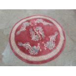 A Chinese pink ground rug. 48' diam