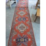 A red ground carpet runner. 16' long