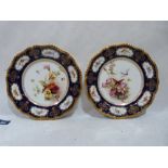 A pair of Royal Worcester cabinet plates gilded and painted in enamels with summer flowers to the