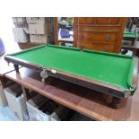 A 19th century mahogany snooker table with slate bed raised on six adjustable reeded feet (one A.