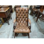 A mahogany and buttoned leather upholstered rocking chair