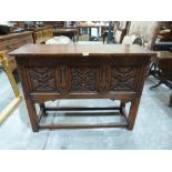 A 17th century style joined oak carved chest raised on stile legs with perimeter stretchers. 42'