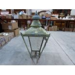 A copper exterior lantern. 32' high. Three glass panes lacking