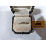 A three stone diamond ring. In gold marked 18. Size O½. 2g gross