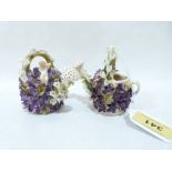 A pair of continental porcelain flower encrusted models of watering cans. 3¼' high. (losses)