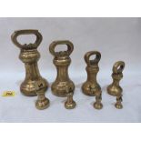 A set of eight brass scale weights