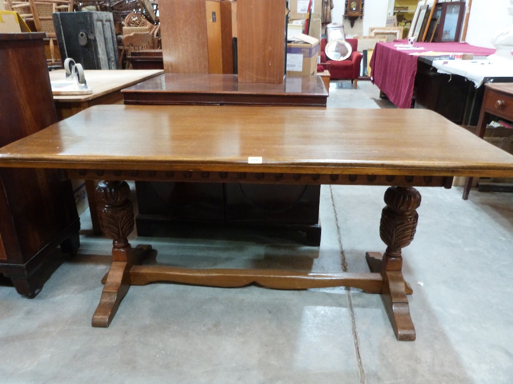 An oak refectory style dining table on carved bulbous supports. 61' long